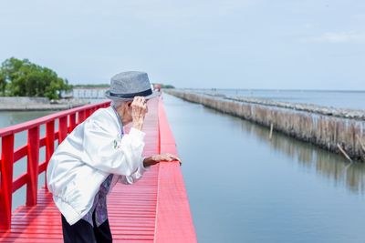 Man standing by sea against sky