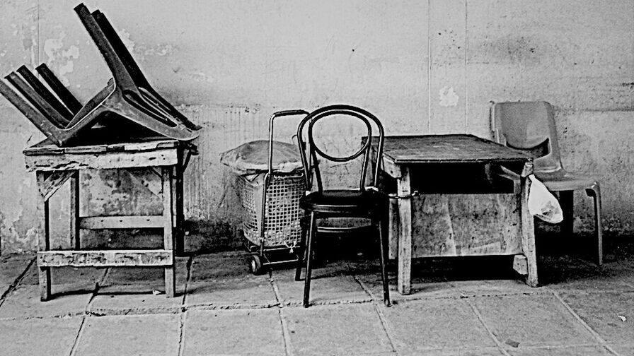 ABANDONED TABLE AND CHAIRS IN ROOM
