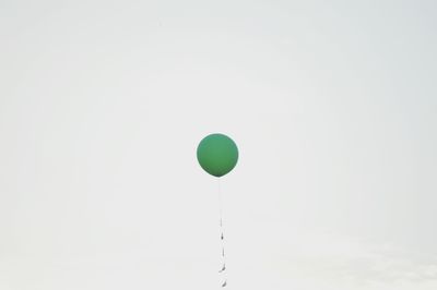 Low angle view of balloons against blue background