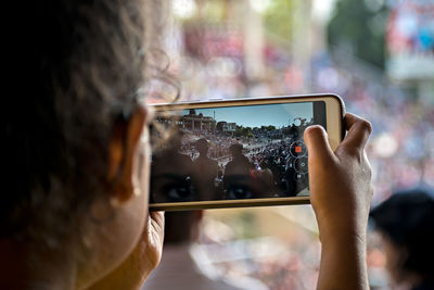 Close-up of woman photographing through smart phone