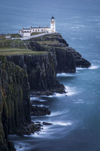 Scenic view of sea by buildings against sky