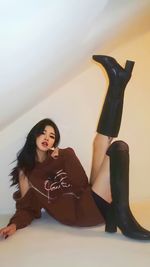 Portrait of young woman sitting on snow