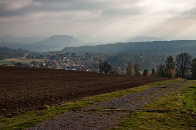 Scenic view of agricultural field against sky