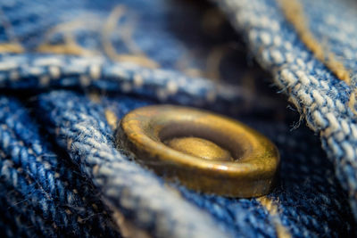 Macro shot of copper button on jeans