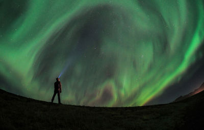 Low angle view of silhouette man standing at night