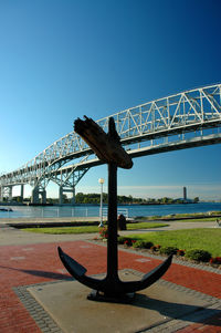 View of bridge over river against blue sky