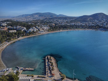 High angle view of townscape by sea against sky