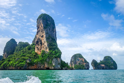 Rock formations in sea against sky