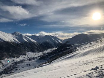 Scenic view of snowcapped mountains against sky