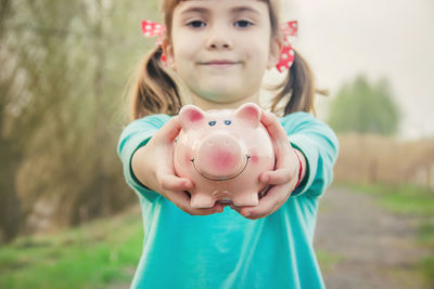 Portrait of cute girl holding heart shape