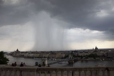 View of bridge over river against cloudy sky