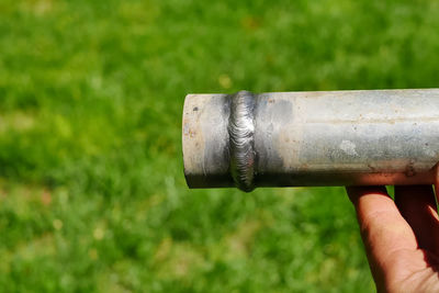 Close-up of human hand holding metal