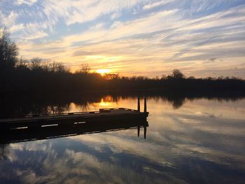 Scenic view of lake at sunset