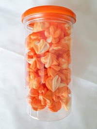 High angle view of orange in glass jar on table