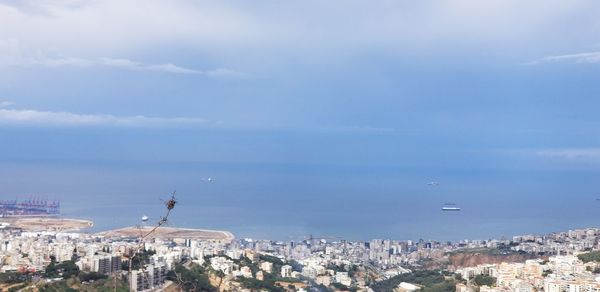 High angle view of buildings by sea against sky