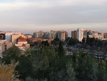 High angle view of trees and buildings against sky