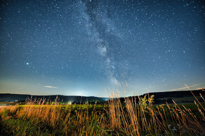 Scenic view of field against sky at night