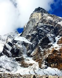 Scenic view of snowcapped mountain against cloudy sky