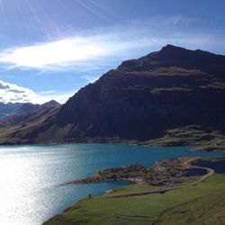 Scenic view of lake and mountains against sky