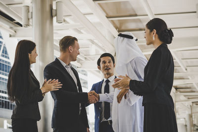 Business people standing on footbridge in city