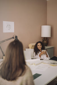 Portrait of woman using digital tablet on table