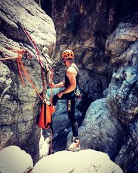 Young man standing in cave