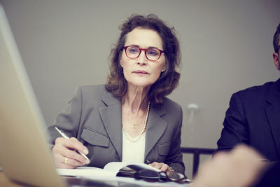 Confident senior female financial advisor working at law office