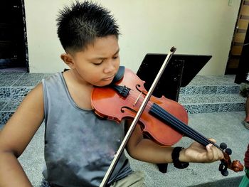High angle view of boy playing violin