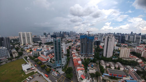 High angle view of modern buildings in city against sky