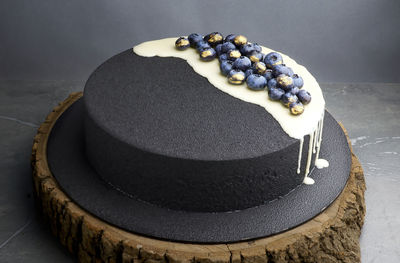 Black velour velvet blueberry cake decorated with black blue fresh berries