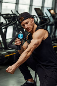 Side view of man exercising in gym