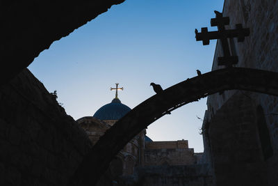 Low angle view of silhouette church against clear sky