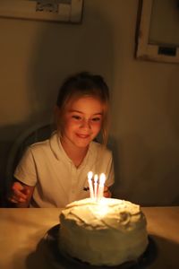 Girl looking at birthday cake