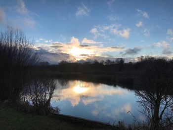 Scenic view of lake against sky during sunset