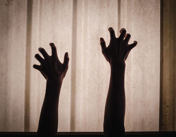 Silhouette man hand against blurred background