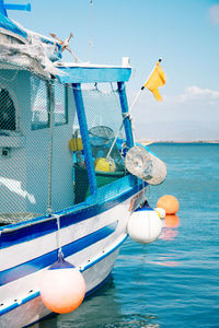 Fishing boat in sea against blue sky