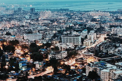 Aerial view of illuminated cityscape against sky