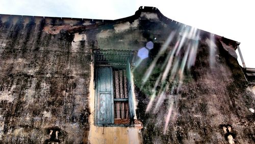 Low angle view of abandoned building against sky