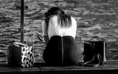 Rear view of woman sitting at park