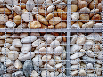 Full frame background of decorative pebble stones wall