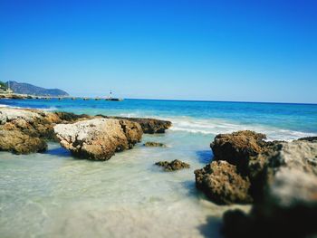 Scenic view of sea against clear blue sky