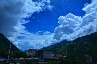 Panoramic view of buildings in town against sky