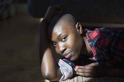 Beautiful young woman relaxing in beam of sunlight