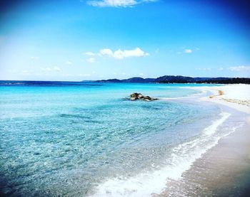 Scenic view of sea against blue sky