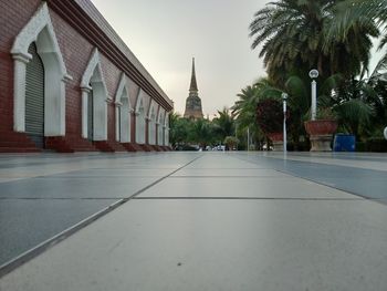 Road amidst buildings against clear sky