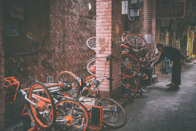 Bicycles on street against wall