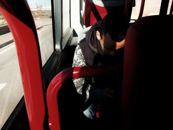 Midsection of man in bus