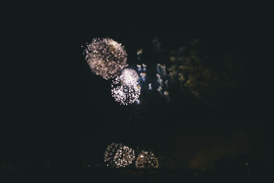 Low angle view of firework display in sky at night