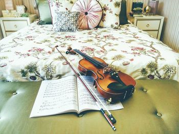 Violin with musical note book in bedroom