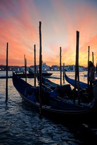 Gondolas moored on grand canal during sunset